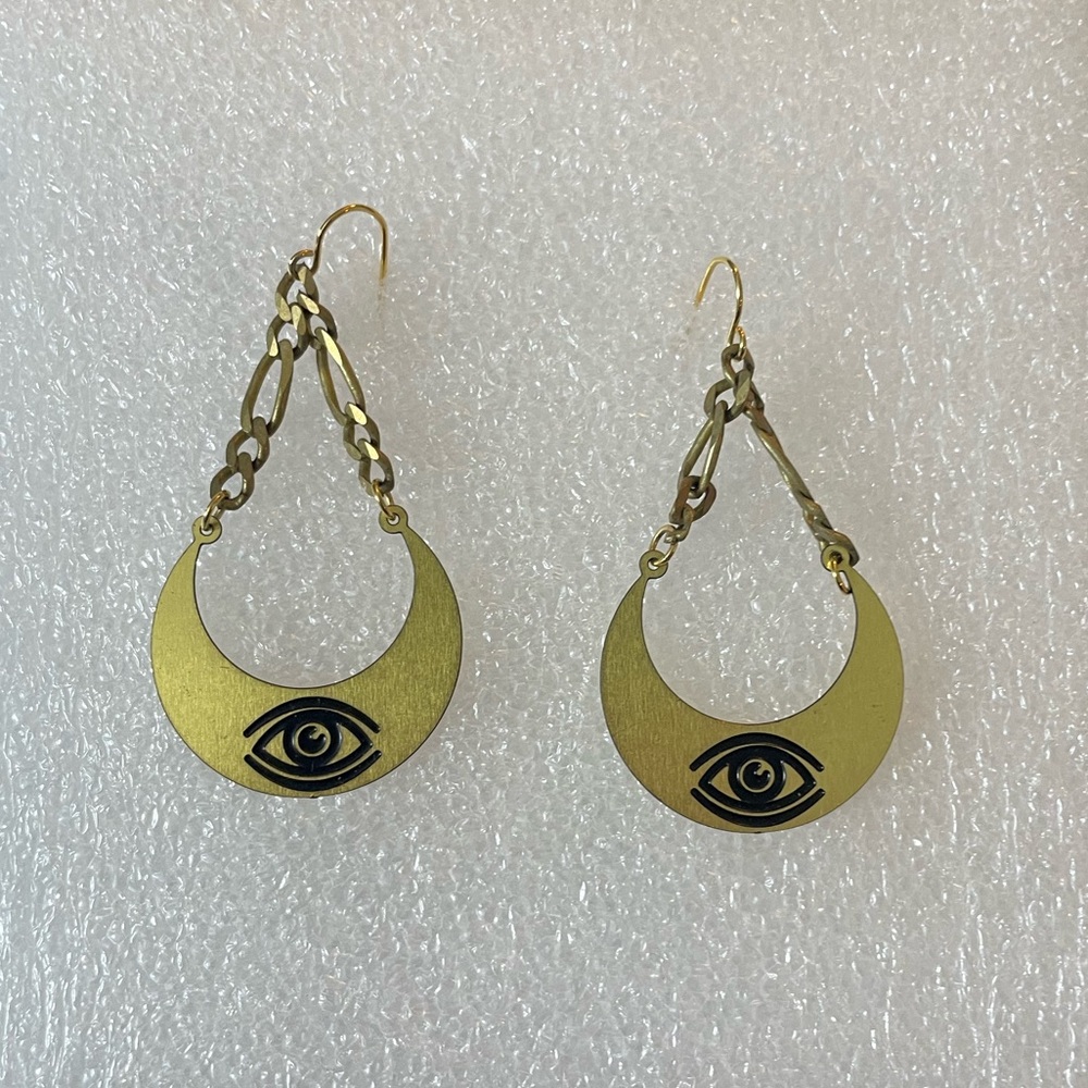Gold/brass colored dangly eye earrings